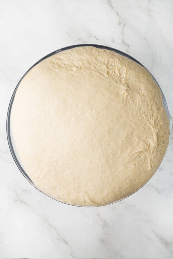 This easy vegan Sandwich Bread Recipe is a home baker's dream. Soft and pillowy with a subtle richness, it's a major upgrade to any sandwich. Vegan sandwich bread dough in a bowl after the first rise.