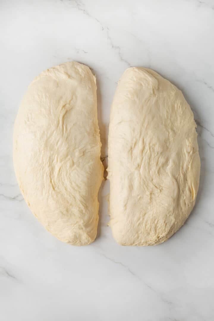 This easy vegan Sandwich Bread Recipe is a home baker's dream. Soft and pillowy with a subtle richness, it's a major upgrade to any sandwich. Bread dough divided into two halves.