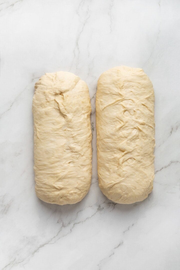 This easy vegan Sandwich Bread Recipe is a home baker's dream. Soft and pillowy with a subtle richness, it's a major upgrade to any sandwich. Two logs of vegan bread dough pinched at the seams.