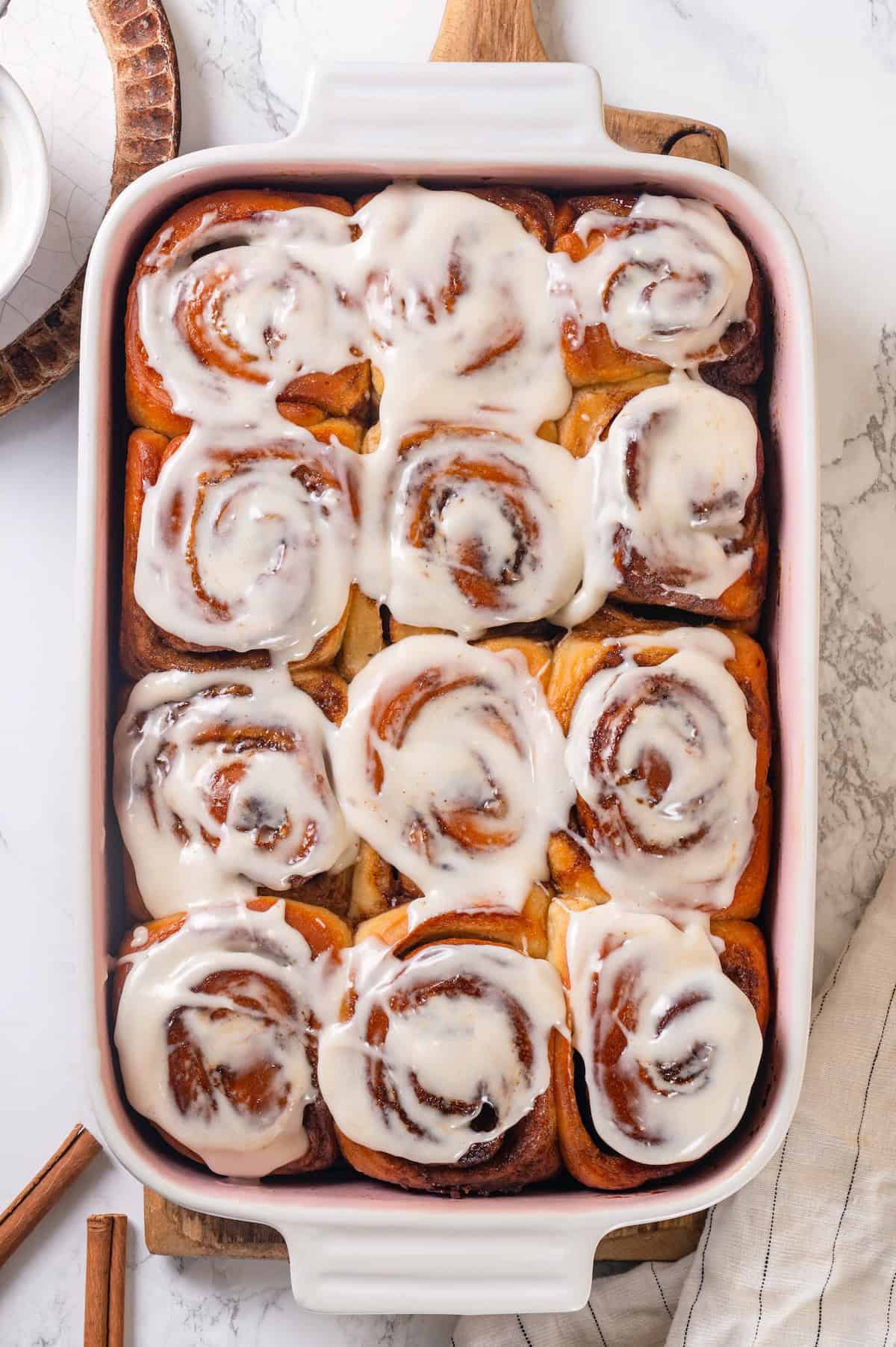 These vegan sourdough cinnamon rolls are impossibly soft, packed with cinnamon sugar filling, and topped with a smooth cream cheese glaze. Vegan sourdough cinnamon rolls smothered with vegan cream cheese glaze.
