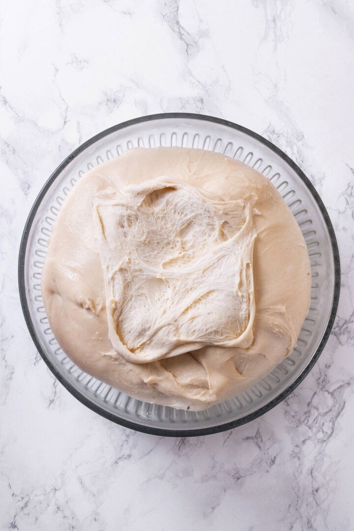 These vegan sourdough cinnamon rolls are impossibly soft, packed with cinnamon sugar filling, and topped with a smooth cream cheese glaze. Sourdough cinnamon roll dough after bulk fermentation.