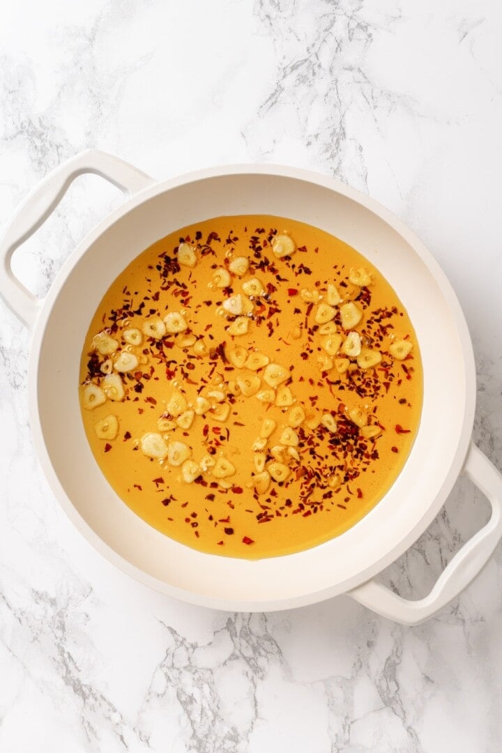 This easy aglio e olio features al dente spaghetti coated in a velvety garlic-infused sauce with a touch of heat from red pepper flakes. Sautéing garlic and red pepper flakes in olive oil.