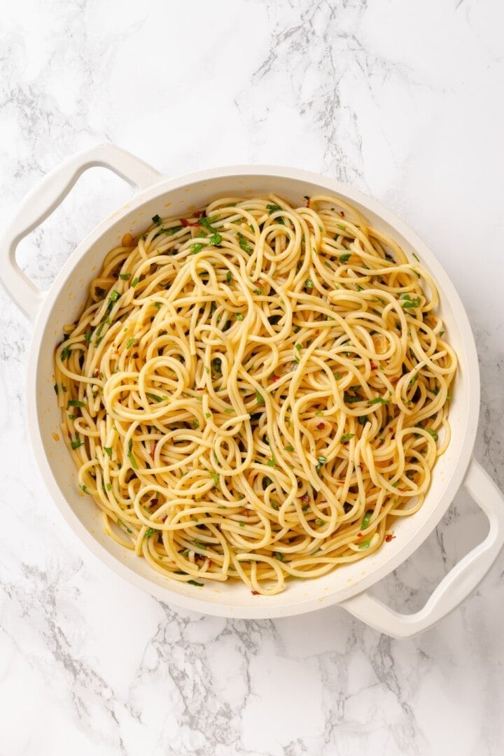 This easy aglio e olio features al dente spaghetti coated in a velvety garlic-infused sauce with a touch of heat from red pepper flakes. Spaghetti aglio e olio finished with parsley, lemon juice, and lemon zest.