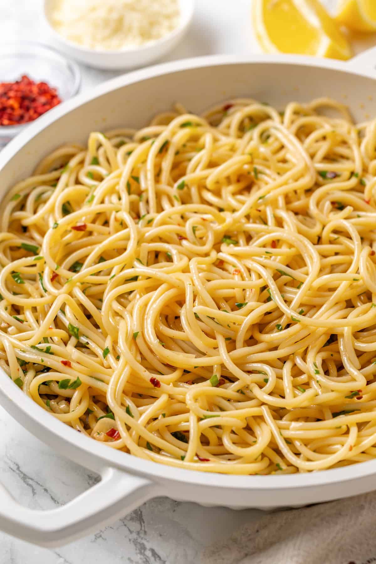 This easy aglio e olio features al dente spaghetti coated in a velvety garlic-infused sauce with a touch of heat from red pepper flakes. Aglio e olio in a pan.