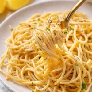 A fork twirling a bite of spaghetti aglio e olio.