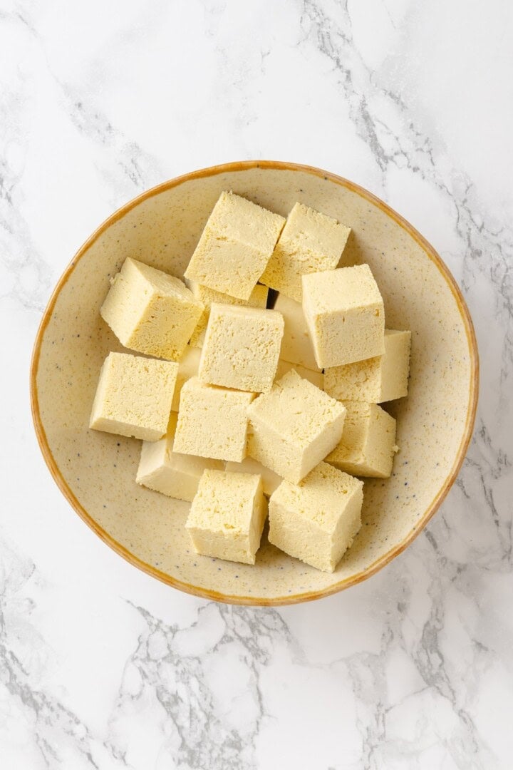 Move over, chicken satay. This tofu satay delivers all the sweet, savoury, tang you crave, with firm caramelised tofu and Thai peanut sauce. Cubed tofu in a bowl.