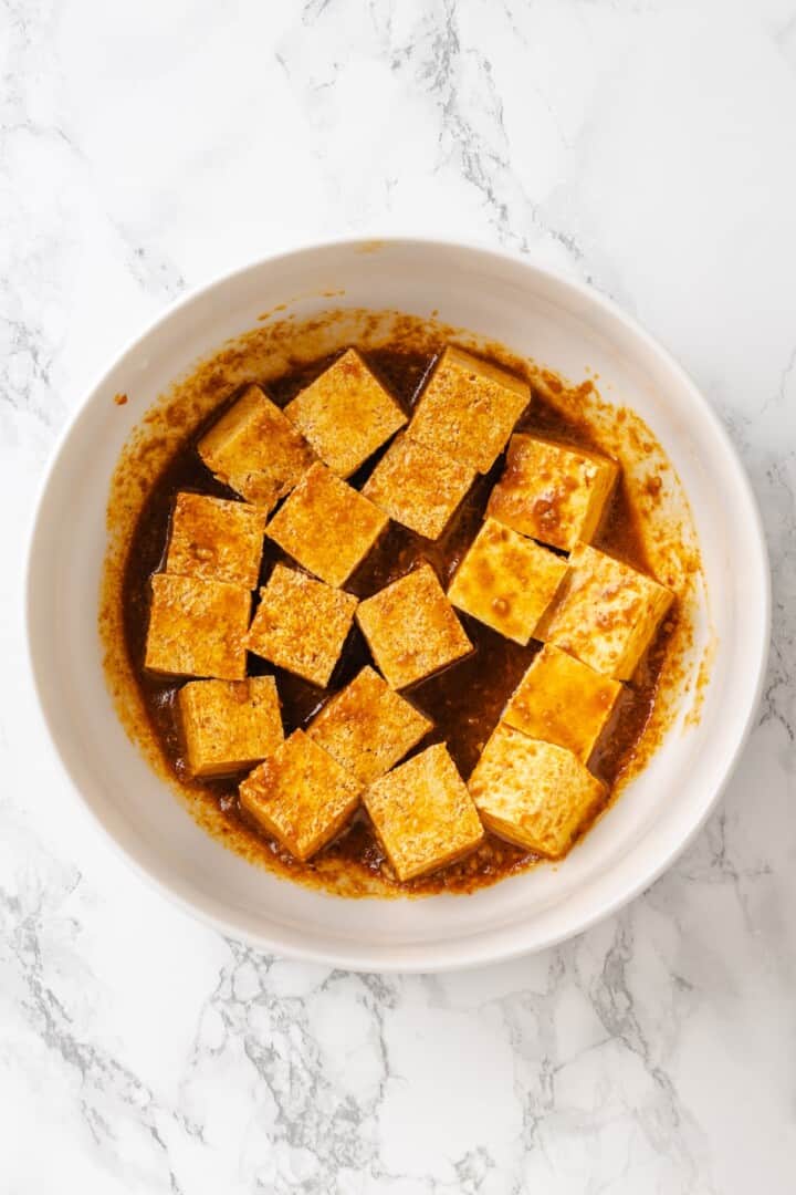 Move over, chicken satay. This tofu satay delivers all the sweet, savoury, tang you crave, with firm caramelised tofu and Thai peanut sauce. Cubed tofu marinating in a Thai-style sauce.