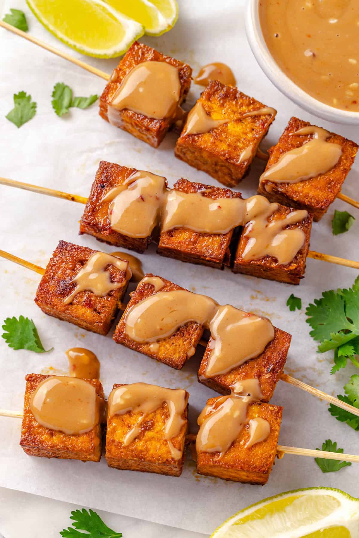 Move over, chicken satay. This tofu satay delivers all the sweet, savoury, tang you crave, with firm caramelised tofu and Thai peanut sauce. Tofu satay drizzled with Thai peanut sauce.