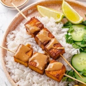 Tofu satay served with jasmine rice, cucumber, lime, and cilantro.