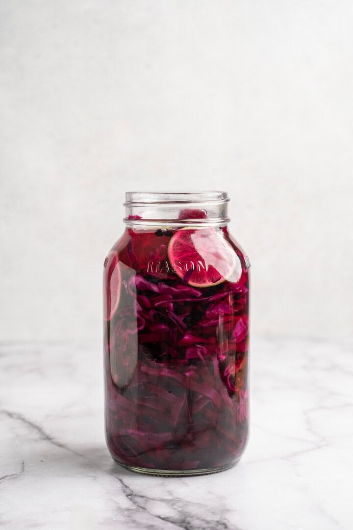 Pickled red cabbage cooling in a mason jar.