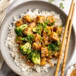 Overhead image of a plate of tempeh stir fry served over rice.