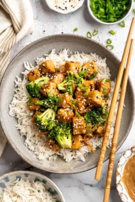 Overhead image of a plate of tempeh stir fry served over rice.