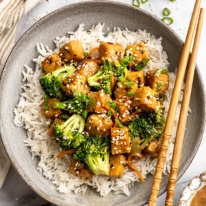 Overhead image of a plate of tempeh stir fry served over rice.
