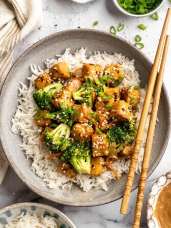 Overhead image of a plate of tempeh stir fry served over rice.