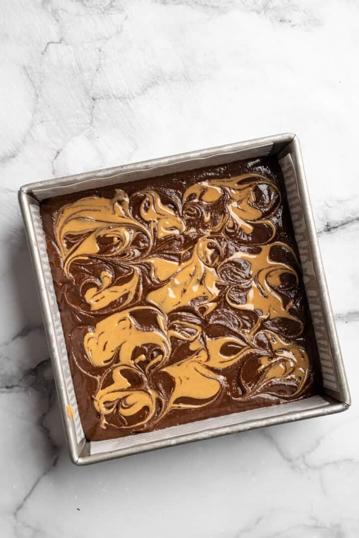 Peanut butter swirl brownies are wonderfully fudge-y, perfectly chewy, and complete with a salty ribbon of peanut butter swirled throughout. Peanut swirl butter brownies ready to go in the oven.