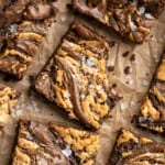 Overhead image of peanut butter swirl brownies. One has a bite taken out of it.