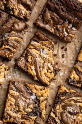 Overhead image of peanut butter swirl brownies. One has a bite taken out of it.