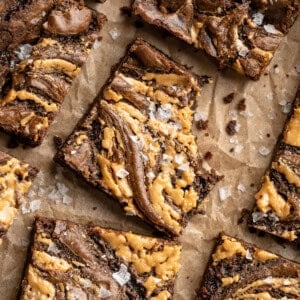 Overhead image of peanut butter swirl brownies. One has a bite taken out of it.