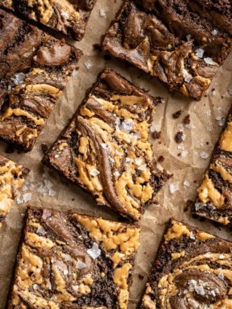 Overhead image of peanut butter swirl brownies. One has a bite taken out of it.