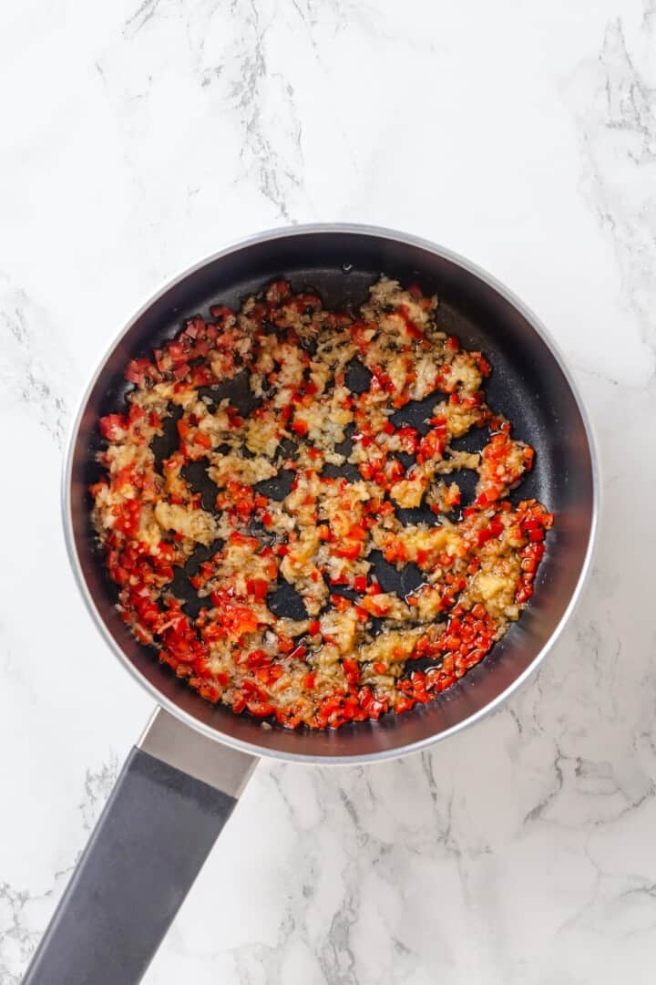 Sweet, savoury, and just a little spicy, this smooth, chunky mango chutney marries traditional Jamaican and Indian flavours beautifully. Sautéing garlic, ginger, and red chili in a pan.