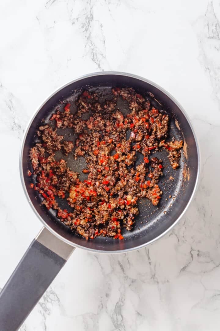 Sweet, savoury, and just a little spicy, this smooth, chunky mango chutney marries traditional Jamaican and Indian flavours beautifully. Toasting spices in a pan full of sautéed garlic, ginger, and red chili.