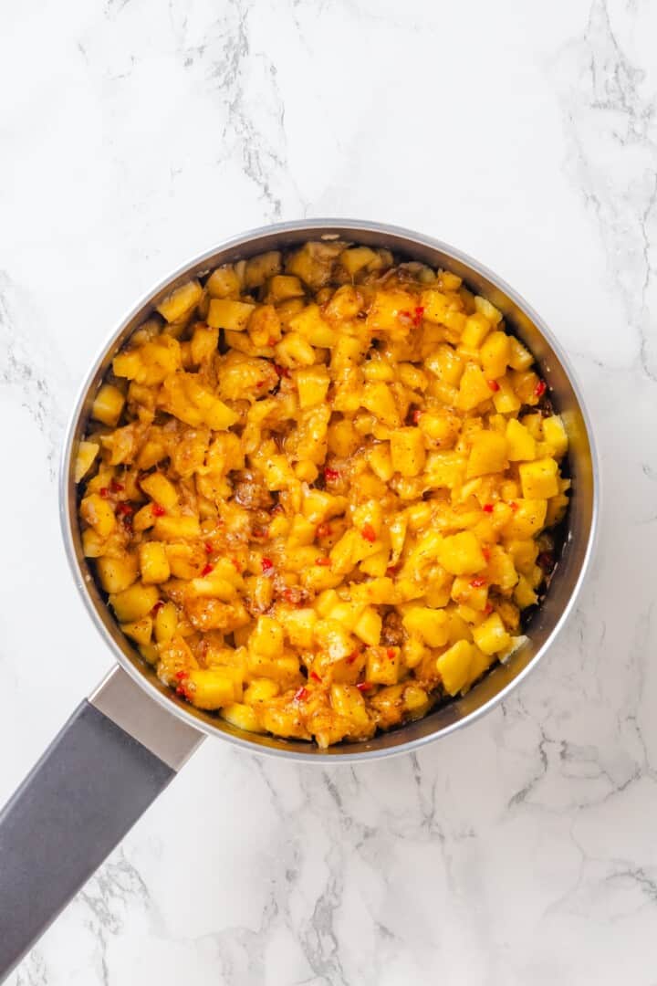 Sweet, savoury, and just a little spicy, this smooth, chunky mango chutney marries traditional Jamaican and Indian flavours beautifully. Adding diced fresh mango to a pan with sautéed aromatics and spices.