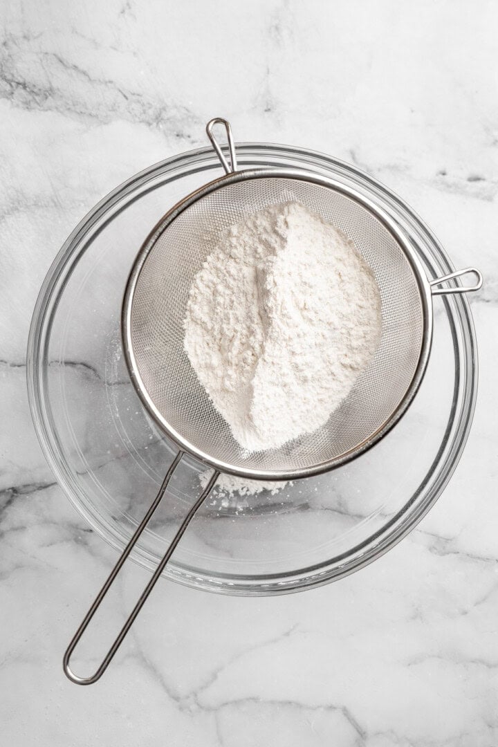 Easy to make and SO light and fluffy, these vegan cottage cheese pancakes are about to become your go-to, protein-packed breakfast. Sifting together flour, baking powder, and salt.