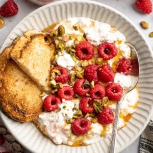 Tofu cottage cheese in a bowl with berries and nuts.