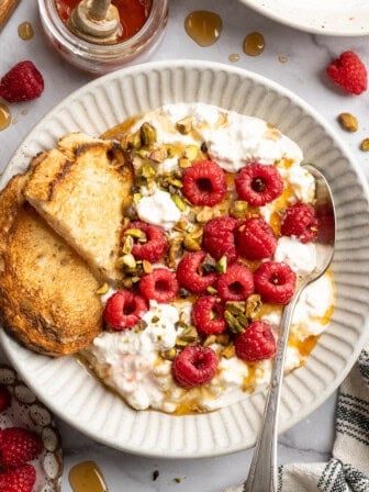 Tofu cottage cheese in a bowl with berries and nuts.