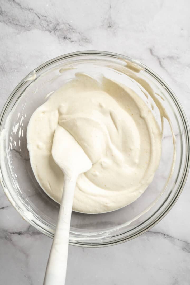 This vegan cottage cheese recipe marinates perfectly tender tofu "curds" in a savoury, tangy, salty sauce. It's a vegan staple you need! Vegan Greek yogurt, nutritional yeast, lemon juice, lactic acid powder, and sea salt mixed together in a bowl.