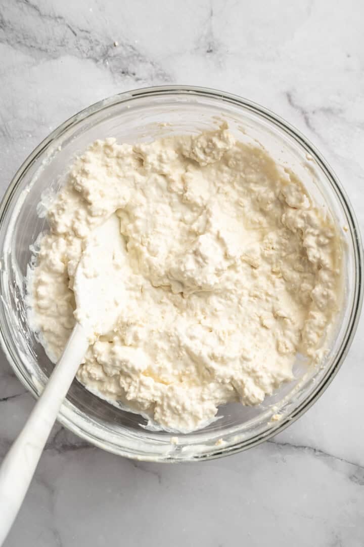 This vegan cottage cheese recipe marinates perfectly tender tofu "curds" in a savoury, tangy, salty sauce. It's a vegan staple you need! Crumbled extra firm tofu tossed into a sauce of vegan Greek yogurt, nutritional yeast, lemon juice, lactic acid powder, and sea salt.