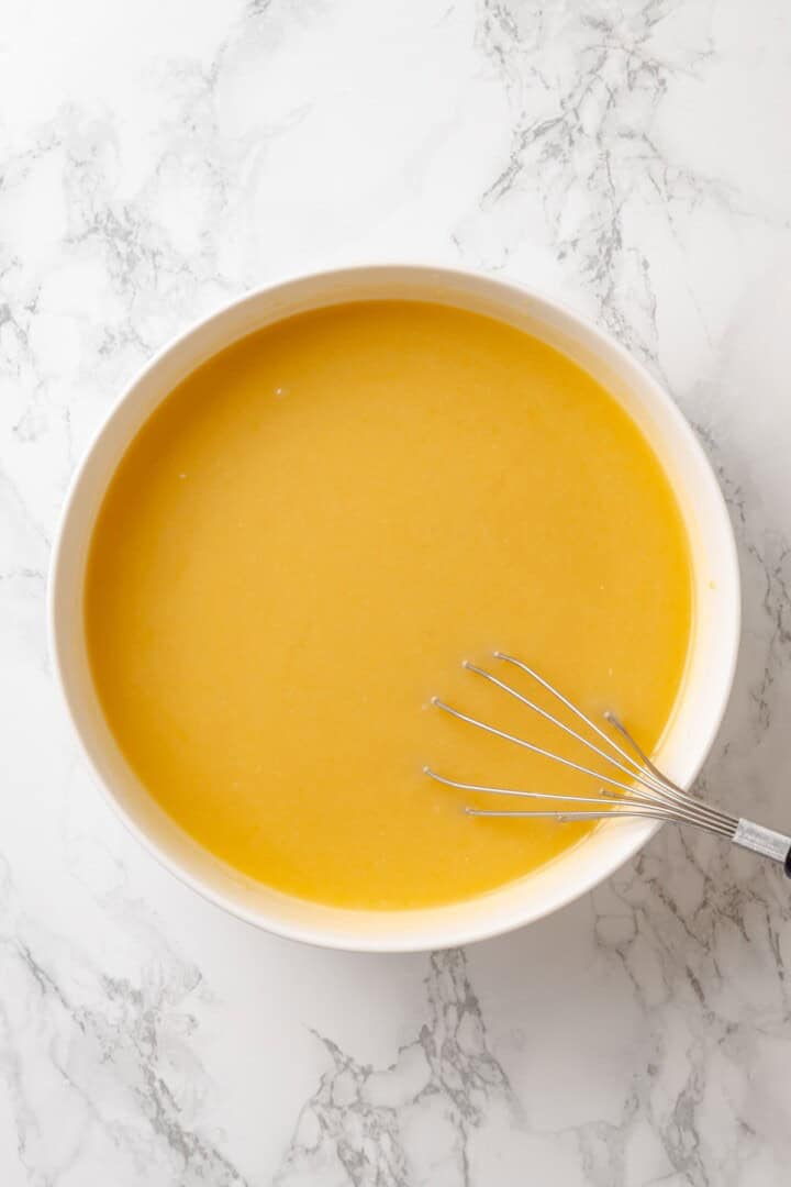 This vegan yellow cake is made of two layers of moist, tender, golden-yellow cake, filled and frosted with silky chocolate buttercream. Whisking together brown sugar, vegan butter, oil, vanilla, and vegan buttermilk for yellow cake batter.