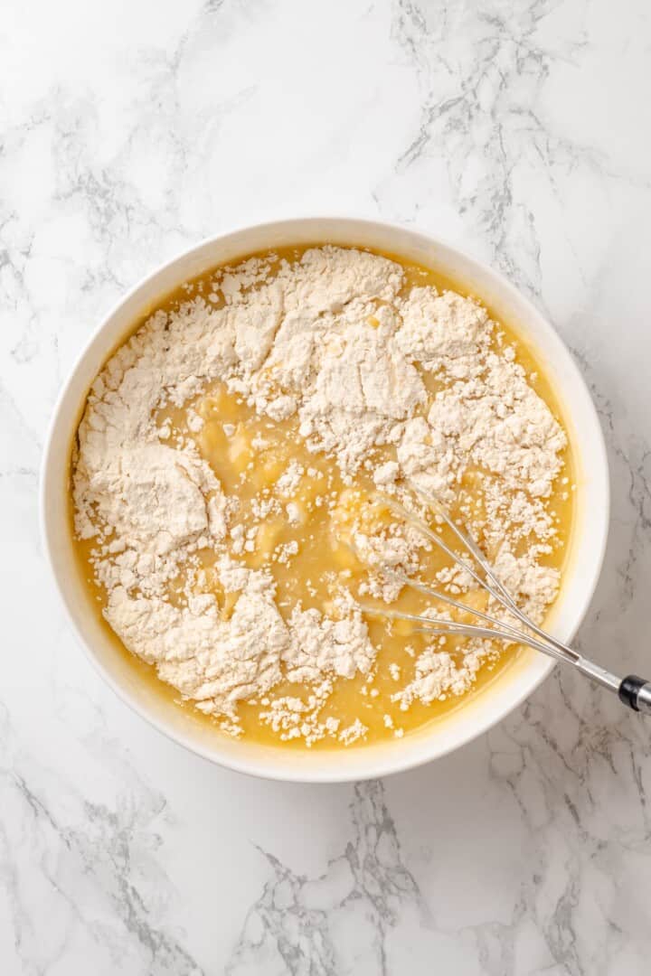 This vegan yellow cake is made of two layers of moist, tender, golden-yellow cake, filled and frosted with silky chocolate buttercream. Adding the dry ingredients to the wet ingredient for yellow cake batter.