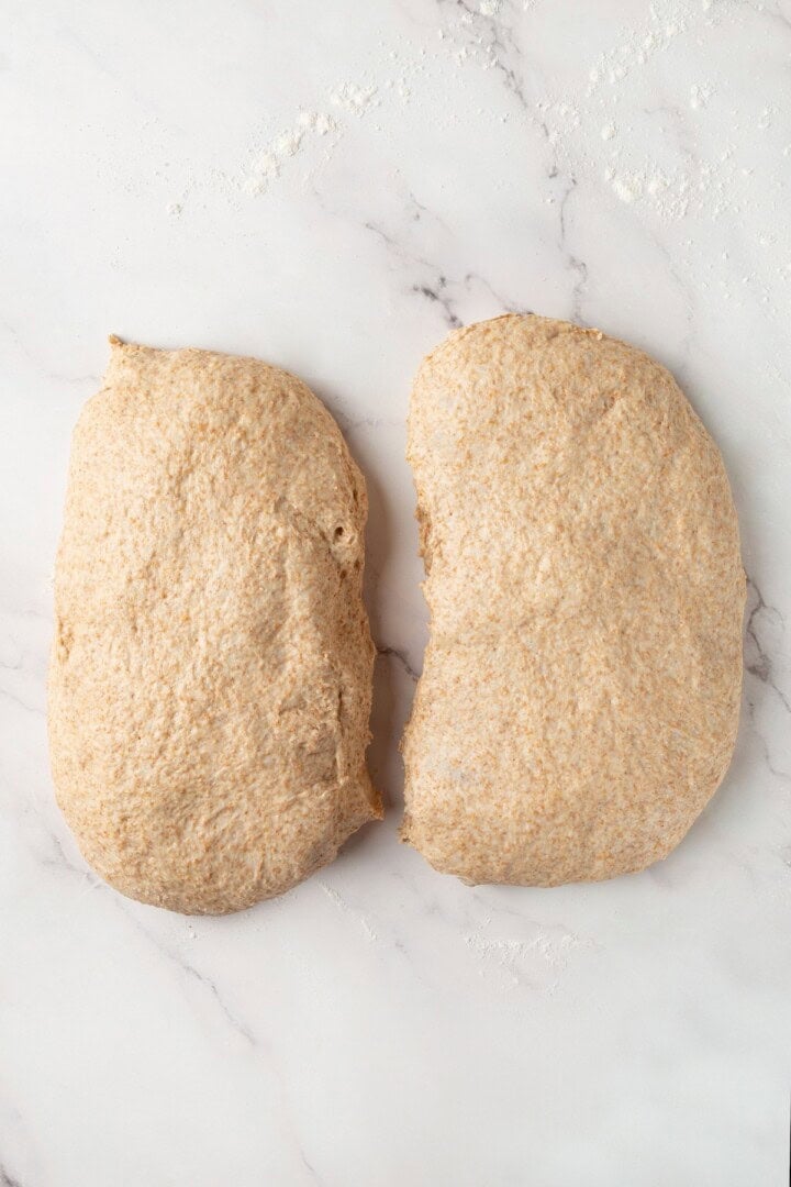 Looking for the perfect slice to build your PB&J or avocado toast on? This soft, tender whole grain sandwich bread is for you. Whole grain bread dough on a floured work surface, divided in half.