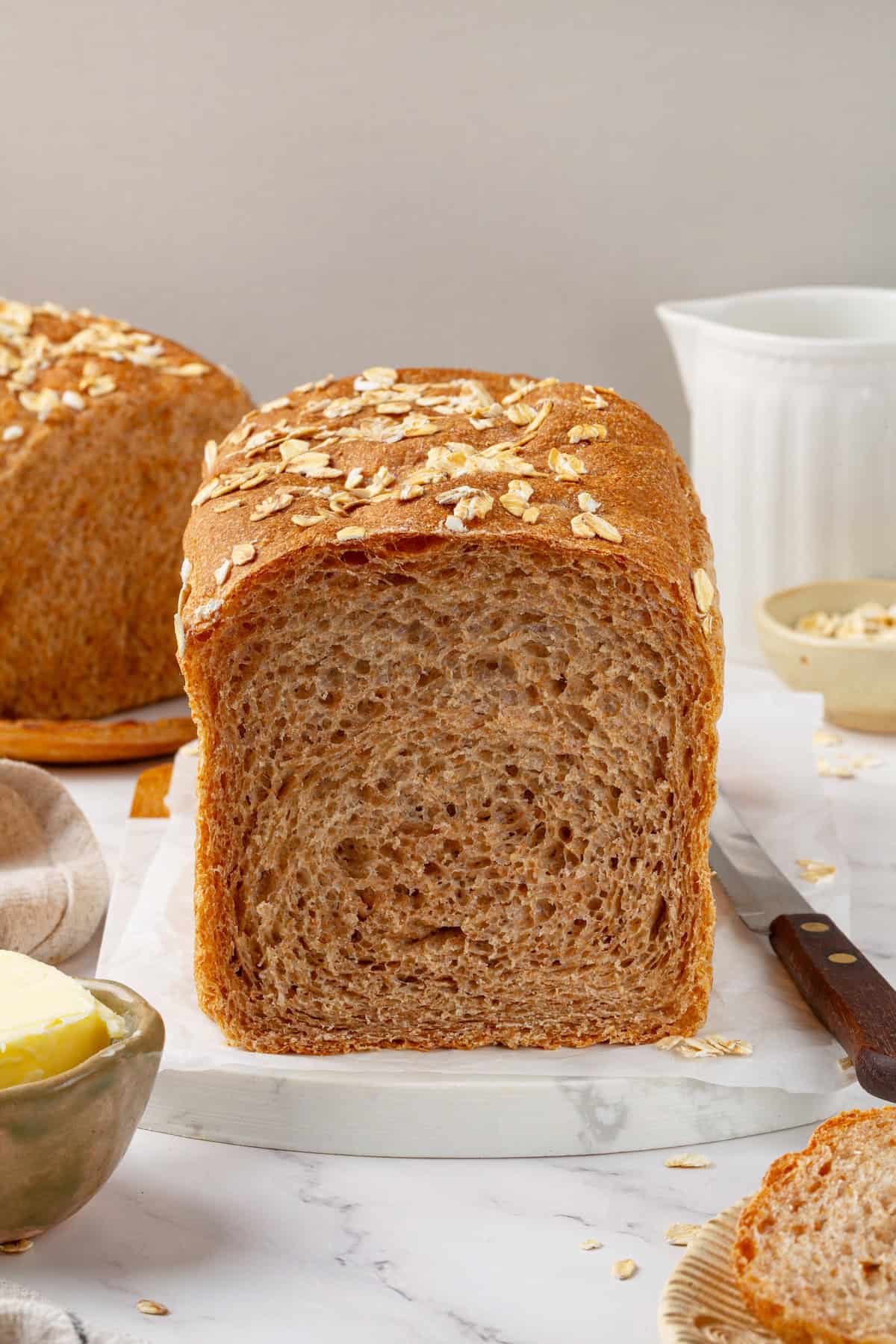 Looking for the perfect slice to build your PB&J or avocado toast on? This soft, tender whole grain sandwich bread is for you. A loaf of whole grain sandwich bread cut open to reveal a tender crumb.