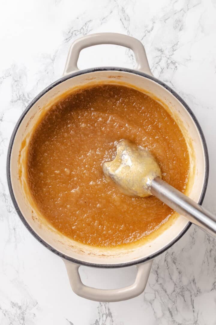 Apple butter should be the first on your autumn to-make list. Smooth and glossy, it's bursting with all the cozy spices of the season. Blended apple butter in a Dutch oven before reducing/thickening.