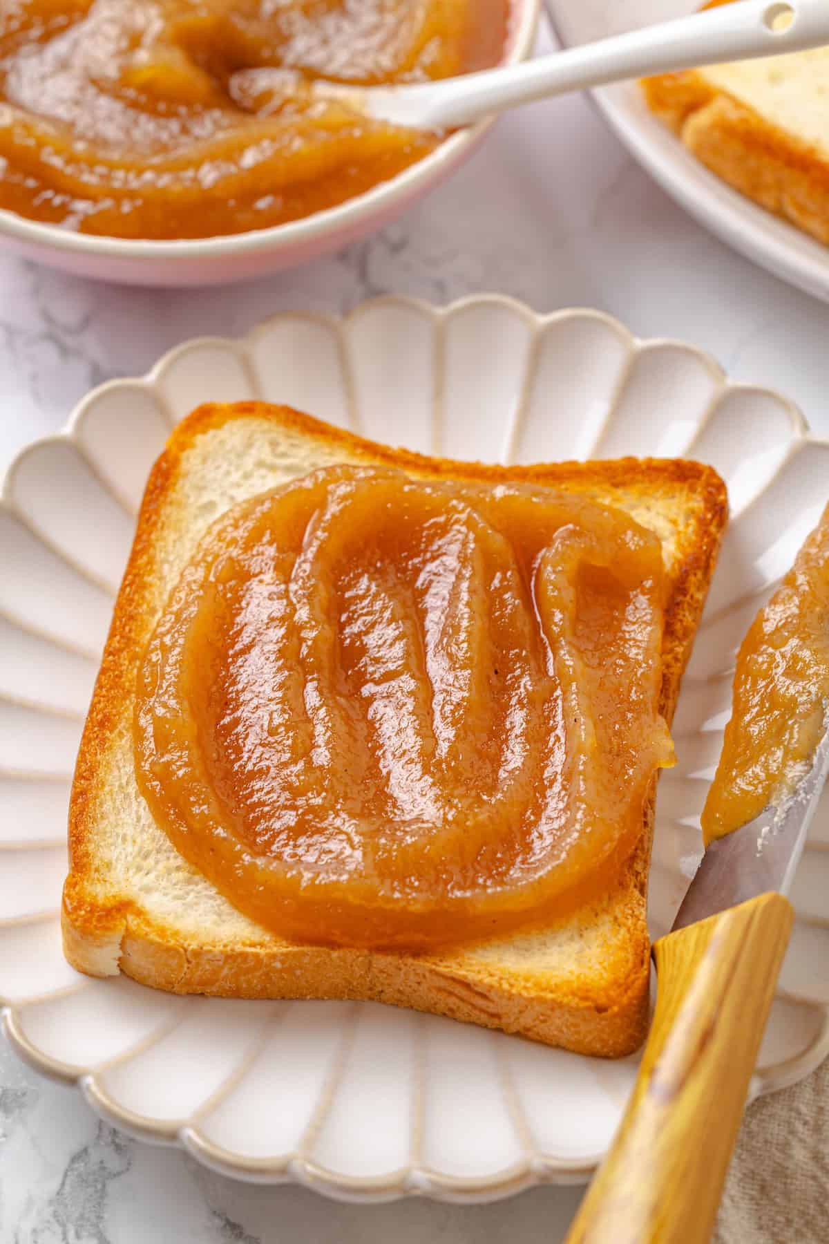 Apple butter should be the first on your autumn to-make list. Smooth and glossy, it's bursting with all the cozy spices of the season. Apple butter spread on toast.