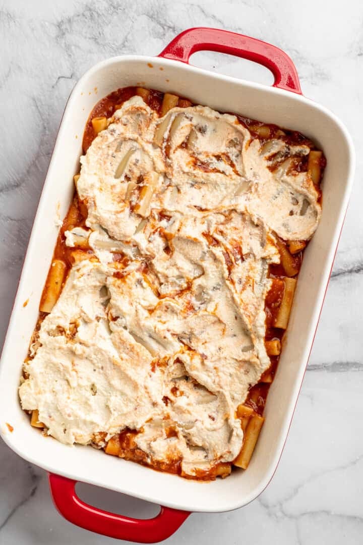 Vegan baked ziti, with its al dente noodles, savoury marinara sauce, and gooey cheese, married together bite after bite, is true comfort food. Topping saucy, vegan meaty ziti pasta with vegan ricotta cheese.