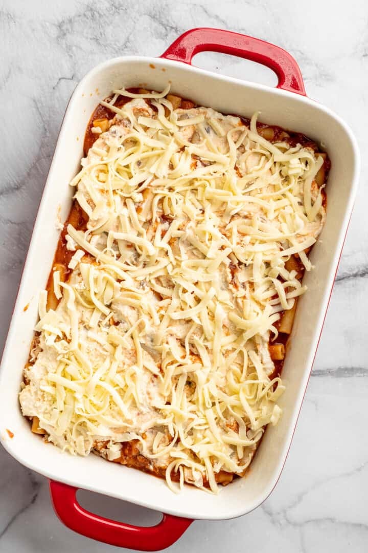 Vegan baked ziti, with its al dente noodles, savoury marinara sauce, and gooey cheese, married together bite after bite, is true comfort food. Adding a layer of shredded vegan mozzarella to ricotta topped saucy ziti.