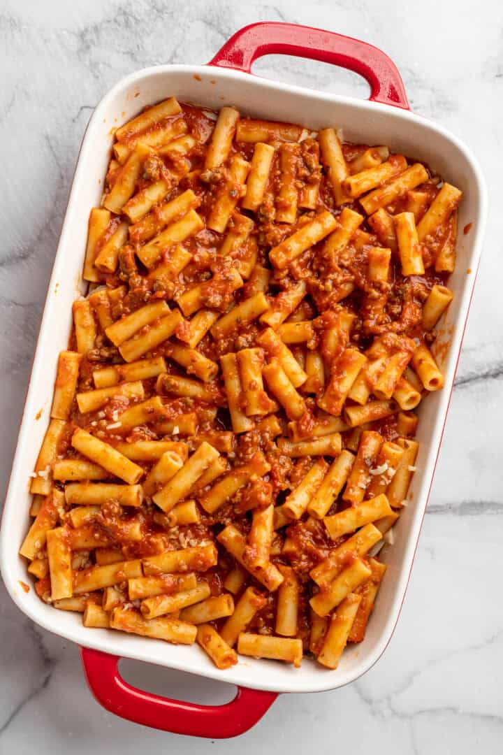 Vegan baked ziti, with its al dente noodles, savoury marinara sauce, and gooey cheese, married together bite after bite, is true comfort food. Adding a second layer of saucy, vegan meaty ziti to a baking dish.