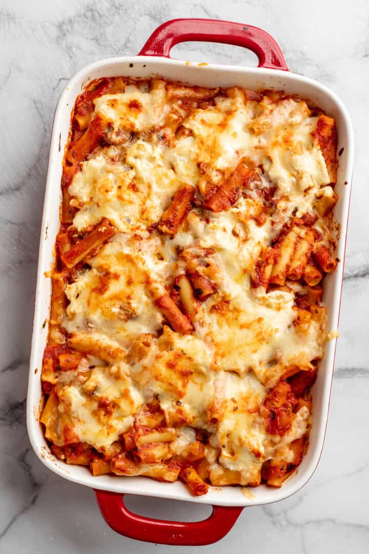 Vegan baked ziti, with its al dente noodles, savoury marinara sauce, and gooey cheese, married together bite after bite, is true comfort food. Vegan baked ziti fresh out of the oven.