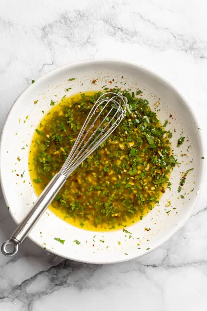 Bursting with zippy lime, sweet, citrusy cilantro, and a hit of garlic, this golden-brown cilantro lime marinated tofu is perfect for tacos. Olive oil, cilantro, garlic, lime juice, lime zest, seasonings, and maple syrup whisked together in a bowl.