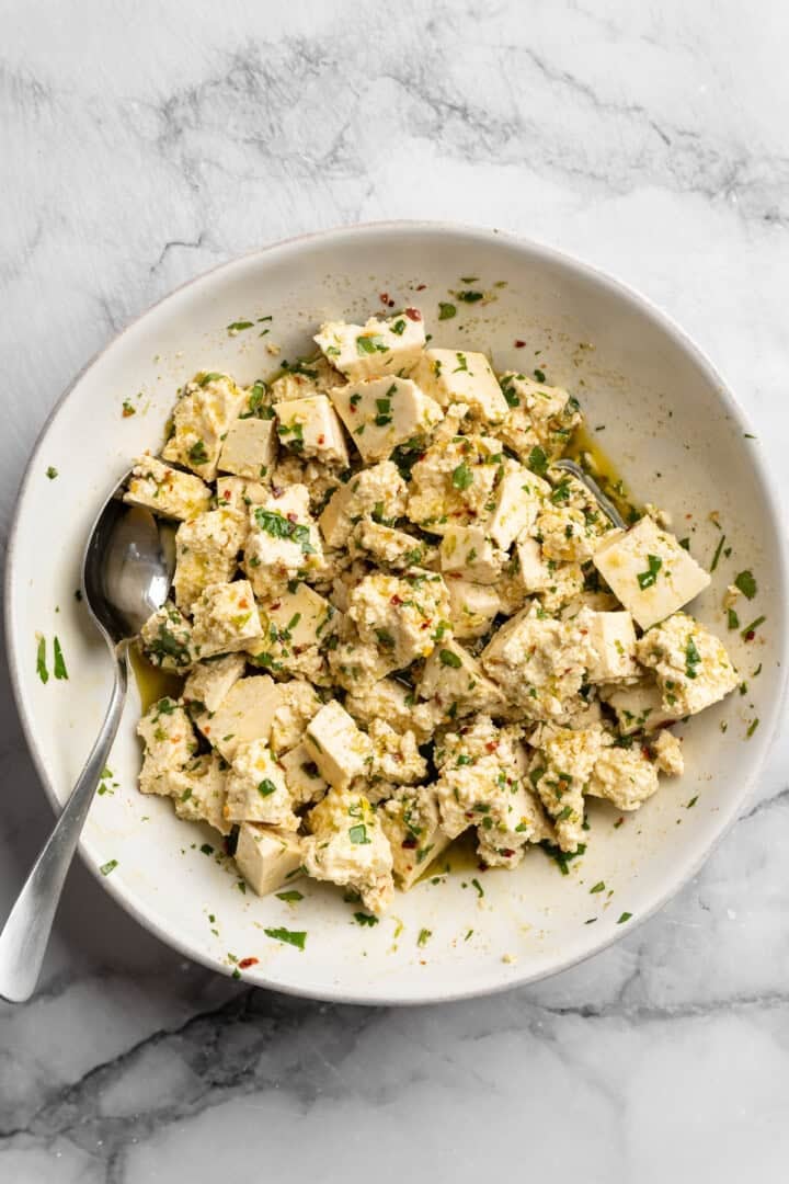 Bursting with zippy lime, sweet, citrusy cilantro, and a hit of garlic, this golden-brown cilantro lime marinated tofu is perfect for tacos. Tossing torn tofu in a cilantro lime marinade.