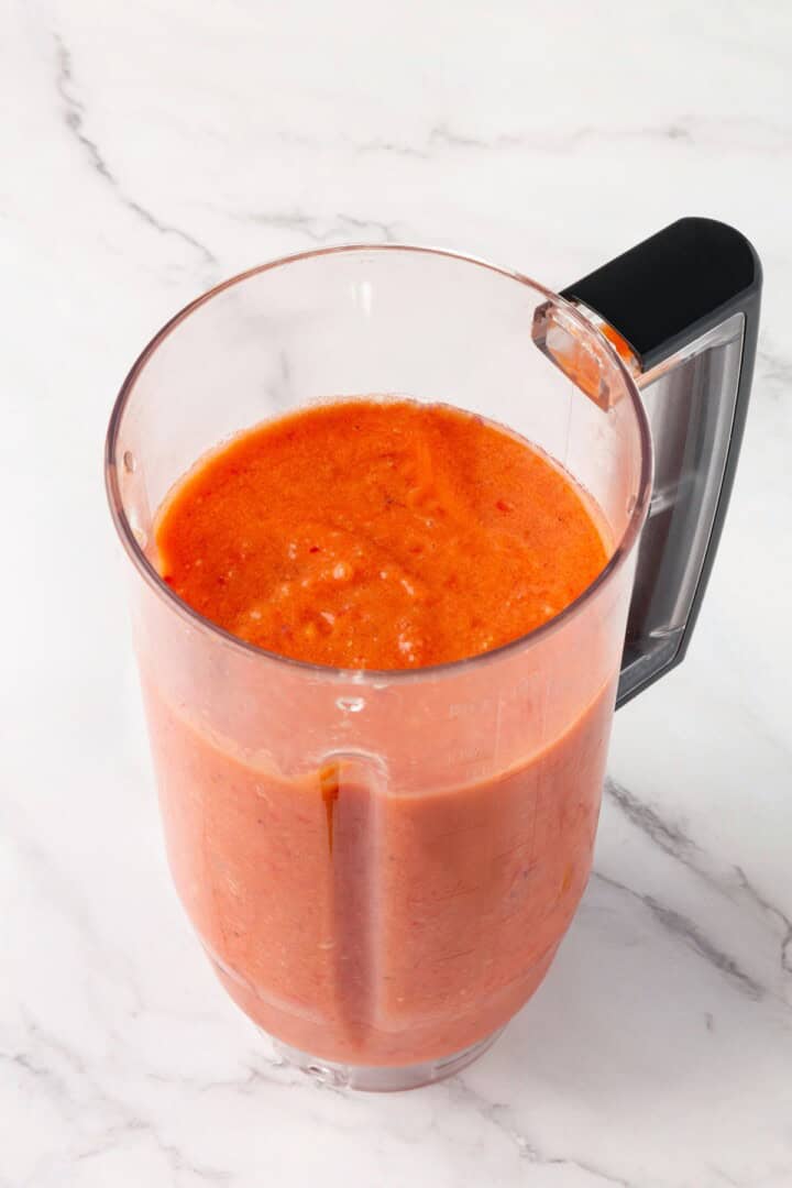 This gazpacho recipe blends farmers' market tomatoes with fresh veggies, olive oil, and vinegar for the perfect sweet 'n tangy summer soup. A blender full of gazpacho.