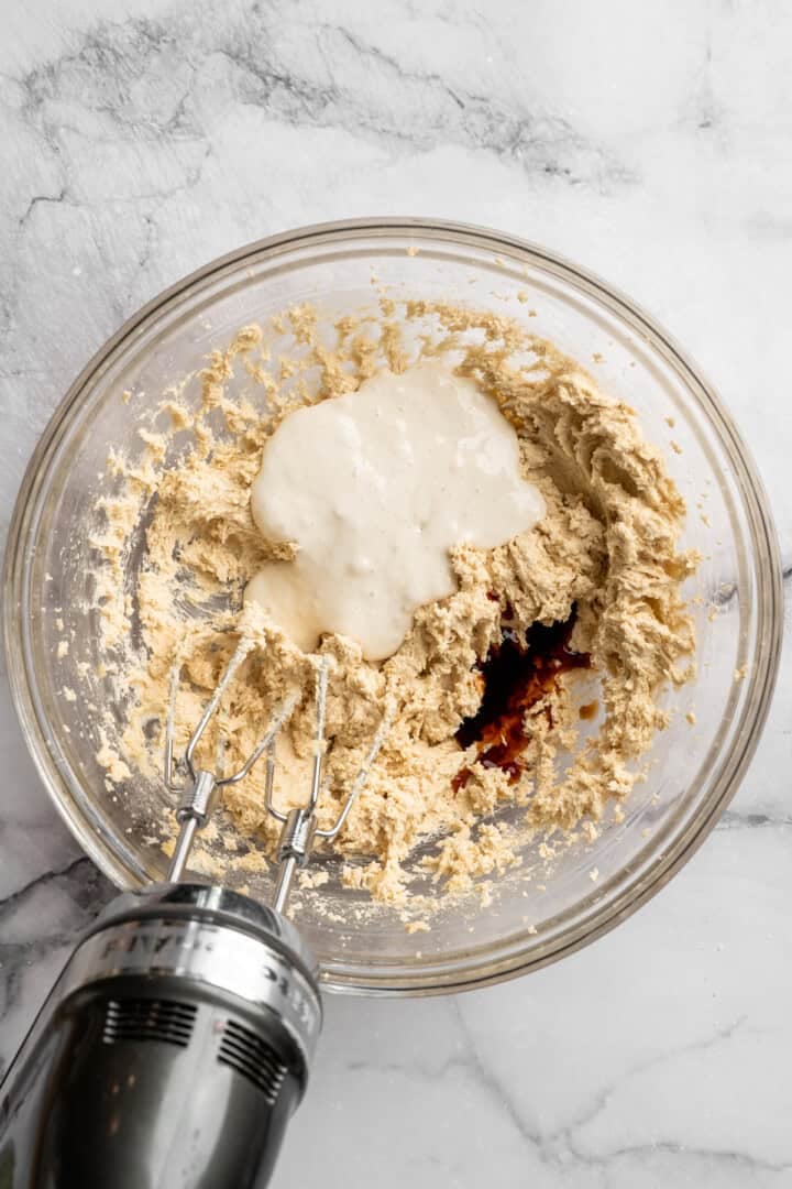 These vegan sourdough chocolate chip cookies are about to up your cookie standards. They're tender and chewy with a subtle sourdough tang. Adding sourdough discard and vanilla to creamed butter and sugar.