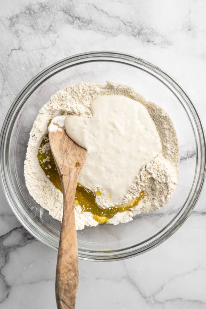 What to do with that sourdough discard? These easy sourdough discard crackers are crunchy, crispy, and flaky, with that best sourdough tang. Adding sourdough discard and olive oil to a bowl with flour, nutritional yeast, seasonings, and lactic acid powder.