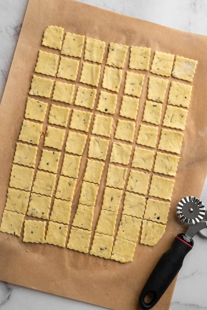 What to do with that sourdough discard? These easy sourdough discard crackers are crunchy, crispy, and flaky, with that best sourdough tang. Sourdough discard cracker dough cut into squares.