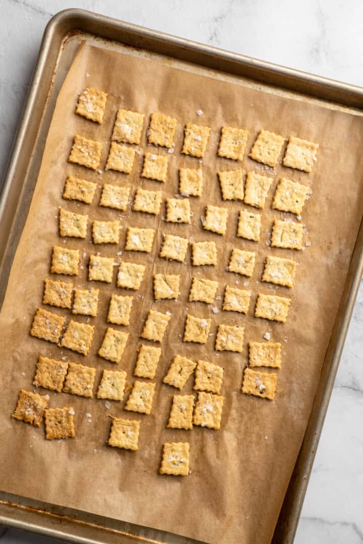 What to do with that sourdough discard? These easy sourdough discard crackers are crunchy, crispy, and flaky, with that best sourdough tang. Sourdough discard crackers on a baking sheet.