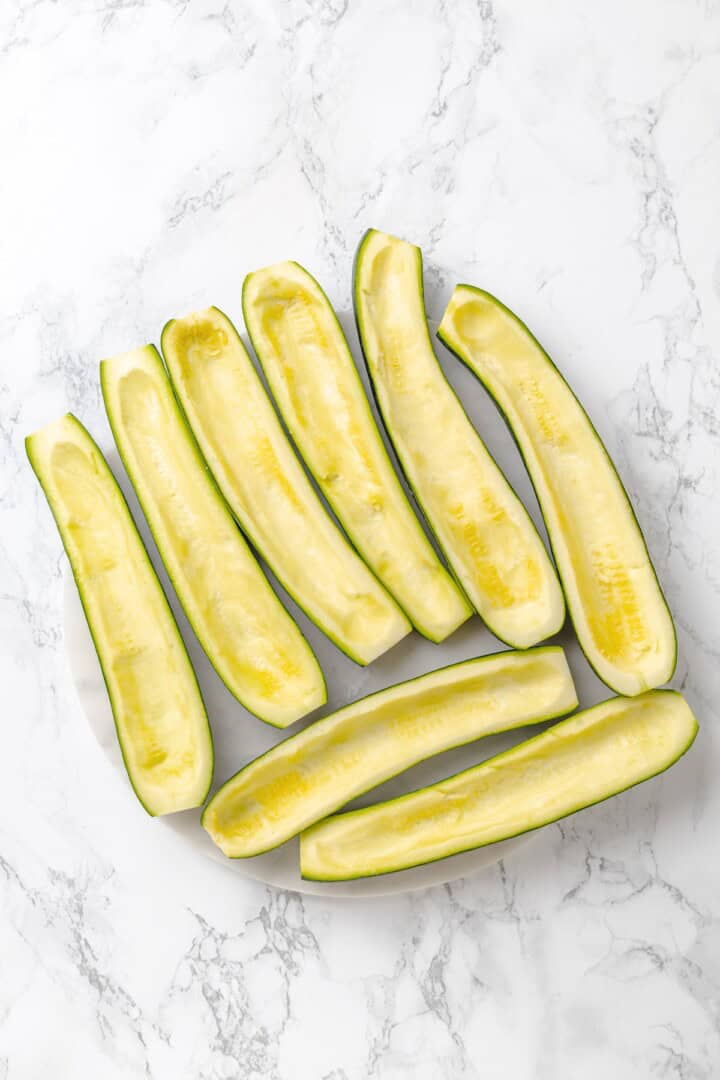 These stuffed zucchini boats are loaded with rich marinara sauce, melty vegan mozzarella, and protein-packed lentils. The perfect summer side. Zucchini boats ready to be filled.