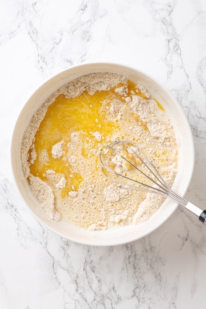 Mixing the wet ingredients into the dry ingredients for vegan cobbler.